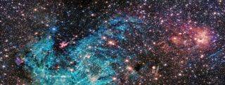 A James Webb Telescope image of the center of the Milky Way showing intersecting red stars and blue filaments of gas.